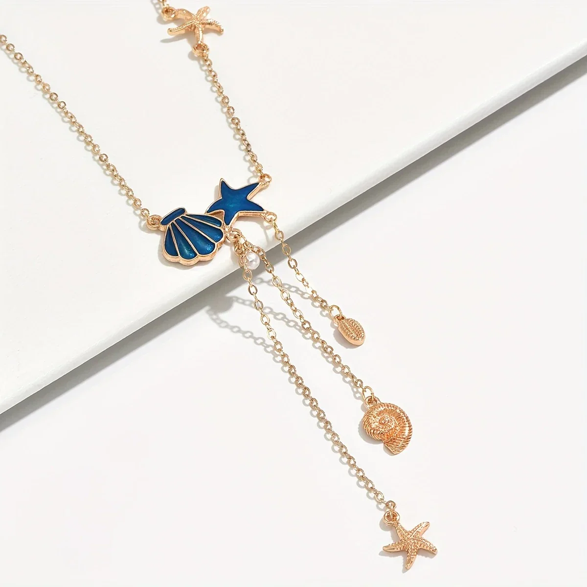 Elegant Gold Necklace with Blue Star and Shell - Image 2